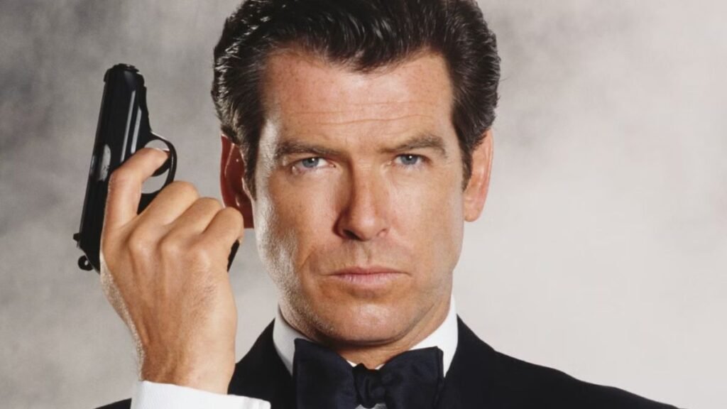 00AP-7 Moment rusty ex-Bond star Pierce Brosnan, 72, is given tips on how to hold a handgun while filming MobLand series 2